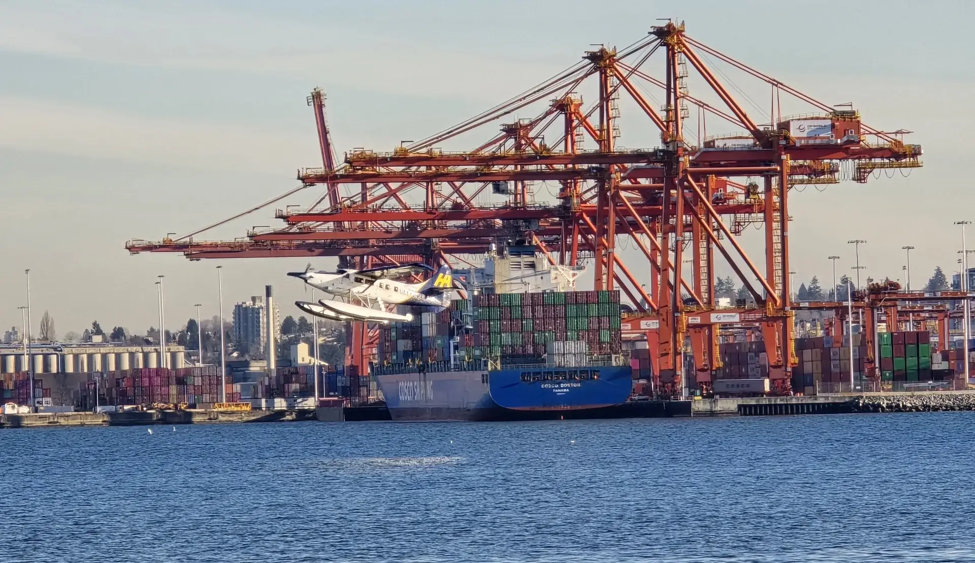 Port of Vancouver with container ships and cargo cranes
